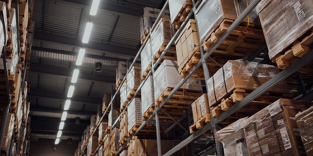 Photo of a warehouse with lots of boxes on shelves.